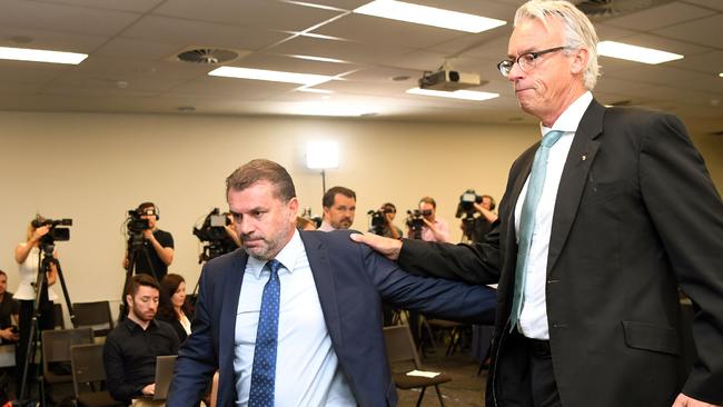 Australia's national football coach Ange Postecoglou leaves a press conference with Football Federation of Australia (FFA) chief David Gallop (R)