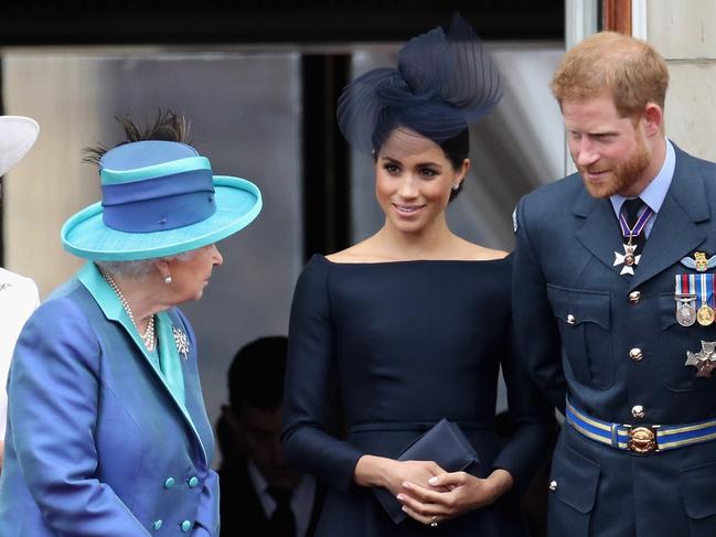 Queen Elizabeth II, Meghan, Duchess of Sussex, Prince Harry, Duke of Sussex in 2018. A royal book claims Harry noticed his photo was missing from the Queen’s Christmas collection. Picture: Getty Images