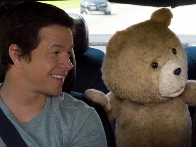 In this image released by Universal Pictures, Mark Wahlberg , from left, the character Ted, voiced by Seth MacFarlane, and Amanda Seyfried appear in a scene from "Ted 2." (Universal Pictures via AP)