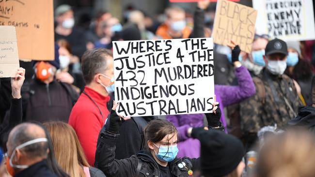 A protester wields a sign at the rally. Picture: Quinn Rooney/Getty Images