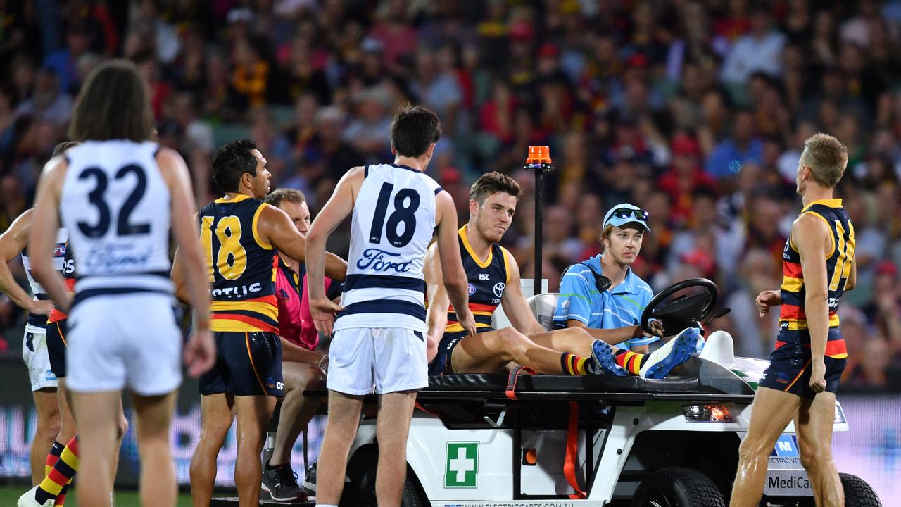 Paul Seedsman of the Crows is taken of the field with a suspected ACL injury. Picture: AAP Image/David Mariuz