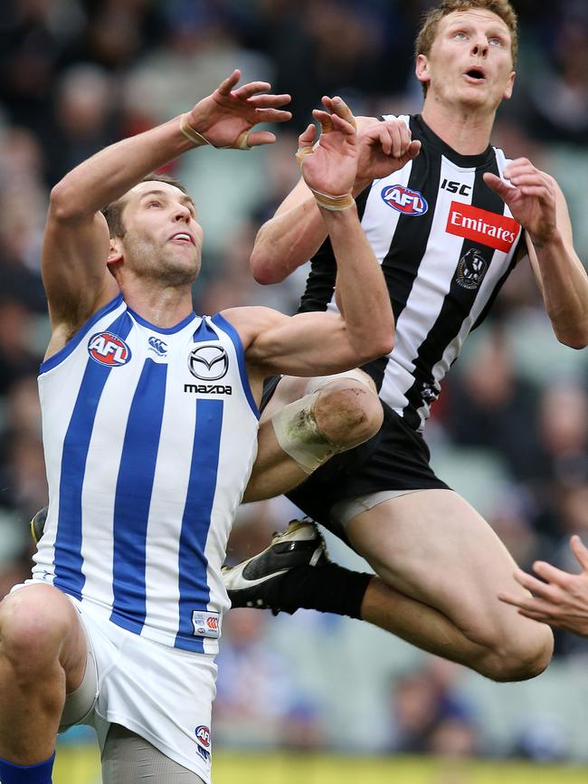 Will Hoskin-Elliott flies over North Melbourne's Jamie Macmillan. Pic: Michael Klein