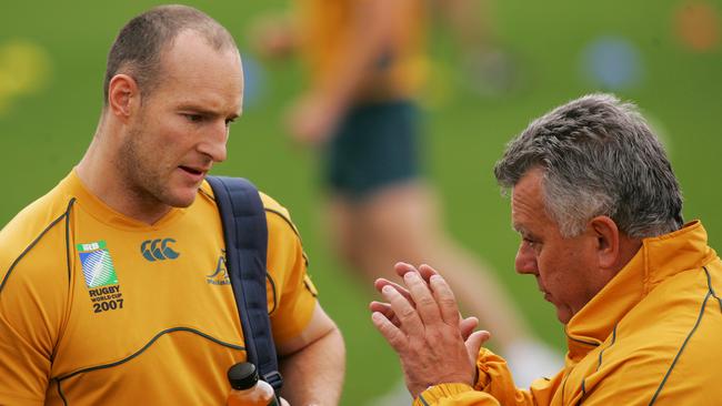 Former Wallabies captain Stirling Mortlock speaks with then coach John Connolly during an Australia training session at Coogee Oval in Sydney.