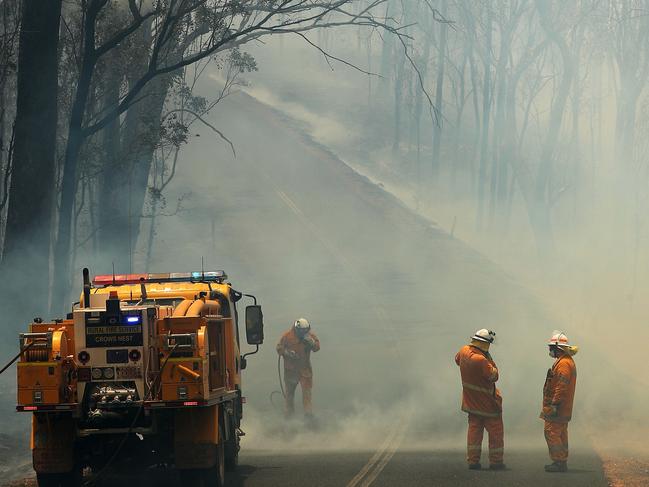 Rural Fire Brigade fighting a bush fire crossing Mount Jockey Rd, Ravensbourne. Photographer: Liam Kidston.