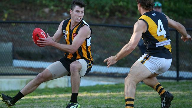 Dillon Devers (Upwey Tecoma) looks for a way past Jake Matthews (Woori Yallock) last season. Picture: Hamish Blair