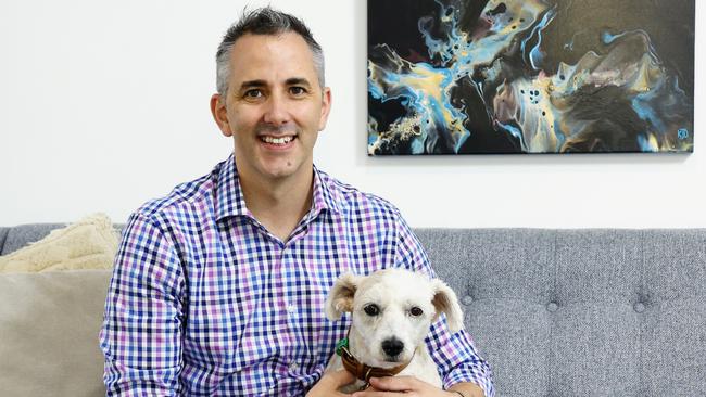 Champions in Real Estate sales agent David Galloway-Penney, pictured at his Earlville home with his West Highland Terrier Cross Rev. Picture: Brendan Radke