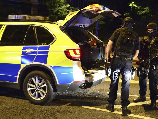 Armed police stand on Borough High Street after an incident in central London. Picture: PA via AP