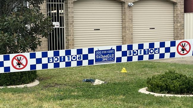 Police have set up a crime scene after a man was found on a lawn outside a residence with multiple stab wounds. Picture: Kate Kiernan