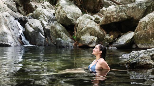 The weather in Far North Queensland is heating up, with the humidity increasing along with the temperatures. Charly Chautard, 19, of Edge Hill, cools off from the hot weather by taking a swim in Stoney Creek at Kamerunga. Picture: Brendan Radke