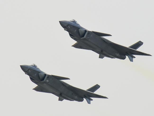 A pair of J-20 stealth fighter jets fly at the China's International Aviation and Aerospace Exhibition in Zhuhai, China's Guangdong province, Tuesday, Nov. 1, 2016. China's J-20 stealth fighter has made its public debut at Airshow China in the southern city in the latest sign of the growing sophistication of the country's military technology. (Chinatopix Via AP)