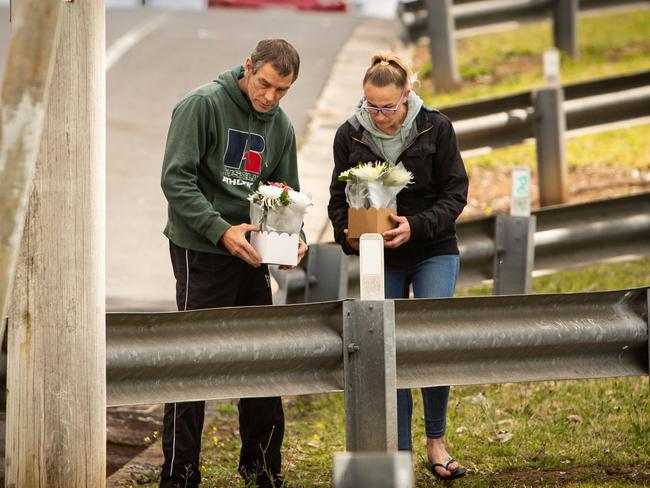 A couple stop by the crash site on Saturday to leave flowers. Picture: Julian Andrews