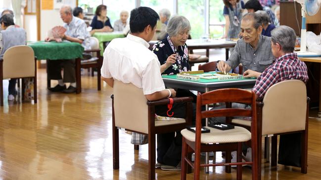 Elderly people play mahjong at a care home in Tokyo. Picture: Bloomberg