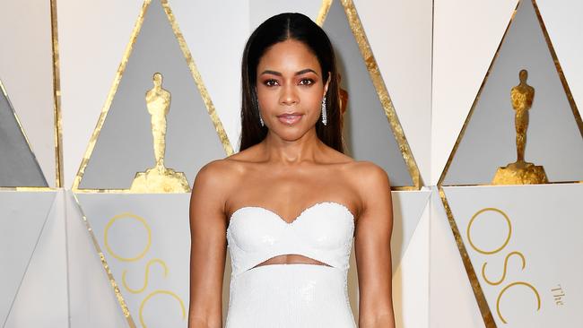 Naomie Harris proving her fashion chops once more. White, sequinned column with under-bust cutout, the new erogenous zone, FYI. Picture: Getty