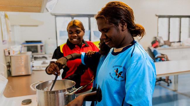 Kids in Jilkminggan in the NT harvesting and cooking fresh produce as part of EON's Thriving Communities program - a grassroots gardening program based around large, edible gardens in remote schools and communities. Picture: Supplied