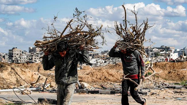 Men collect branches to be used as firewood in the Maghazi camp for Palestinian refugees in the Gaza Strip on Thursday. Picture: AFP