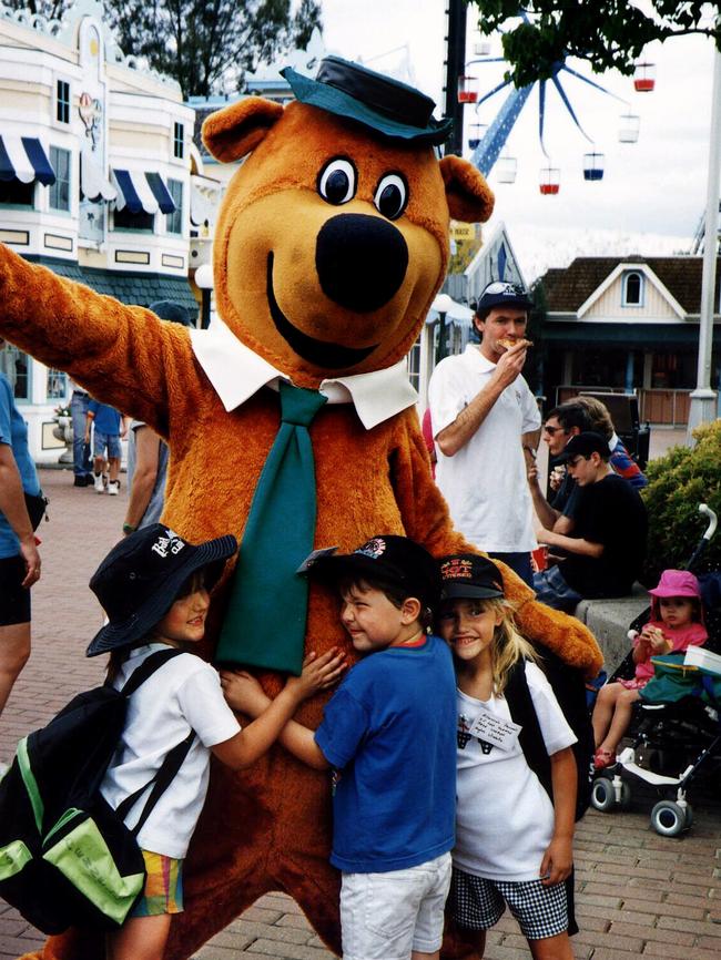 Tourists meeting Yogi Bear in Hanna-Barbera Land.