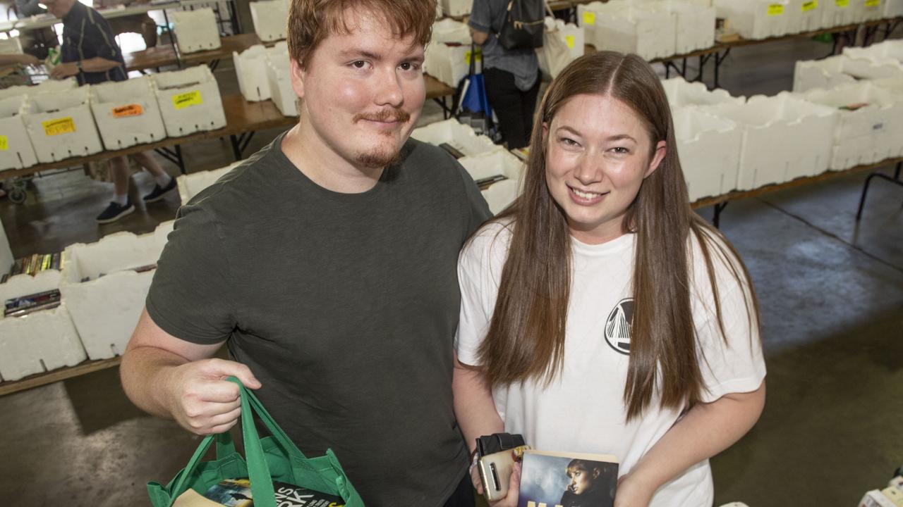 Picking up some bargains at Lifeline BookFest at the Toowoomba Showgrounds are Stuart Clark and Ashley Heron. Saturday, March 4, 2023. Picture: Nev Madsen.