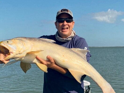 Stephen Purnell with a one-metre-plus king threadfin just prior to releasing it.