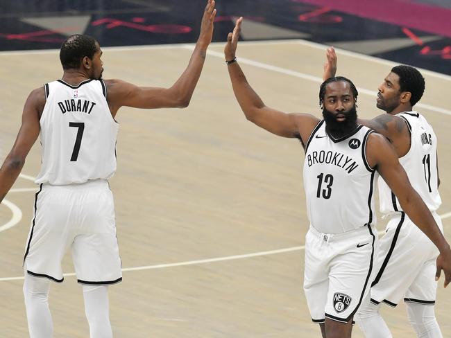 CLEVELAND, OHIO - JANUARY 20: Kevin Durant #7  James Harden #13 and Kyrie Irving #11 of the Brooklyn Nets celebrate during the first quarter against the Cleveland Cavaliers at Rocket Mortgage Fieldhouse on January 20, 2021 in Cleveland, Ohio. NOTE TO USER: User expressly acknowledges and agrees that, by downloading and/or using this photograph, user is consenting to the terms and conditions of the Getty Images License Agreement. (Photo by Jason Miller/Getty Images)