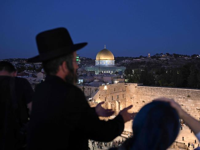 An ultra-Orthodox Jewish man prays at a spot overlooking the Western Wall plaza, ahead of the Global Day of Unity and Prayer with Israelâs Hostages and Missing Families Forum, which represents the relatives of those taken captive by Palestinian Hamas militants during the October 7 attack, in Jerusalem on October 25, 2023. (Photo by Yuri CORTEZ / AFP)