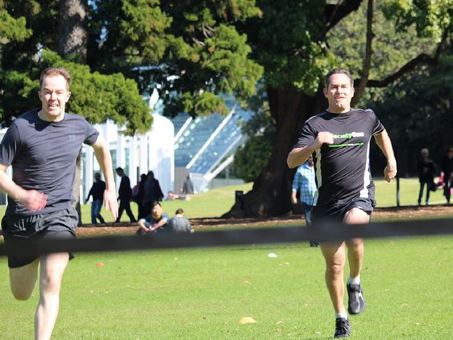 SocietyOne chief executive Jason Yetton (right) trailing Scott Nicholls in the 100m sprint.