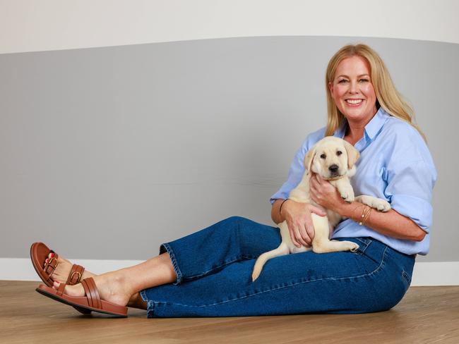 Sam Armytage with guide dog puppy Gypsy, in St Leonards. Picture: Justin Lloyd