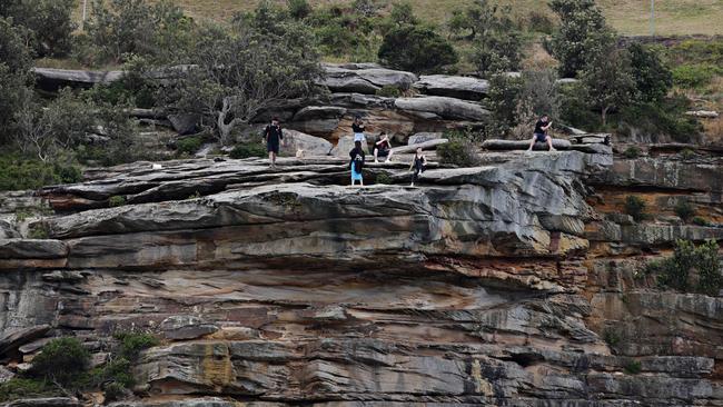 Tourist taking risks at Diamond Bay for the best selfies on Monday. Photographer: Adam Yip