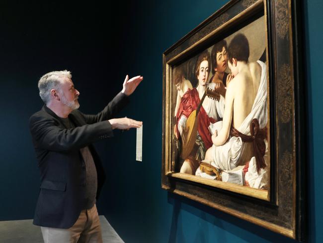 Michael Gallagher from The Metropolitan Museum of Art, New York, with Caravaggio's 'The Musicians'. Picture: Lachie Millard