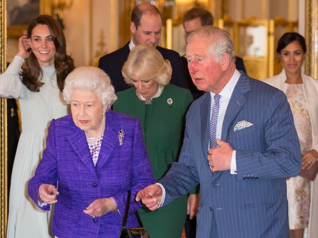 (L-R) Britain's Catherine, Duchess of Cambridge, Britain's Queen Elizabeth II, Britain's Prince William, Duke of Cambridge, Britain's Camilla, Duchess of Cornwall, Britain's Prince Charles, Prince of Wales, Britain's Prince Harry, Duke of Sussex, and Britain's Meghan, Duchess of Sussex attend a reception to mark the 50th Anniversary of the investiture of The Prince of Wales at Buckingham Palace in London on March 5, 2019. - The Queen hosted a reception to mark the Fiftieth Anniversary of the investiture of Britain's Prince Charles, her son, as the Prince of Wales. Prince Charles was created The Prince of Wales aged 9 on July 26th 1958 and was formally invested with the title by Her Majesty The Queen on July 1st 1969 at Caernarfon Castle. (Photo by Dominic Lipinski / POOL / AFP)