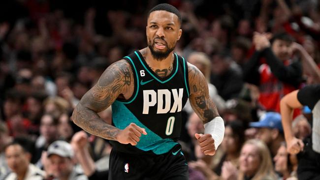 PORTLAND, OREGON - DECEMBER 10: Damian Lillard #0 of the Portland Trail Blazers reacts to making a three point basket during the fourth quarter against the Minnesota Timberwolves at the Moda Center on December 10, 2022 in Portland, Oregon. The Portland Trail Blazers won 124-118. NOTE TO USER: User expressly acknowledges and agrees that, by downloading and or using this photograph, User is consenting to the terms and conditions of the Getty Images License Agreement.   Alika Jenner/Getty Images/AFP (Photo by Alika Jenner / GETTY IMAGES NORTH AMERICA / Getty Images via AFP)