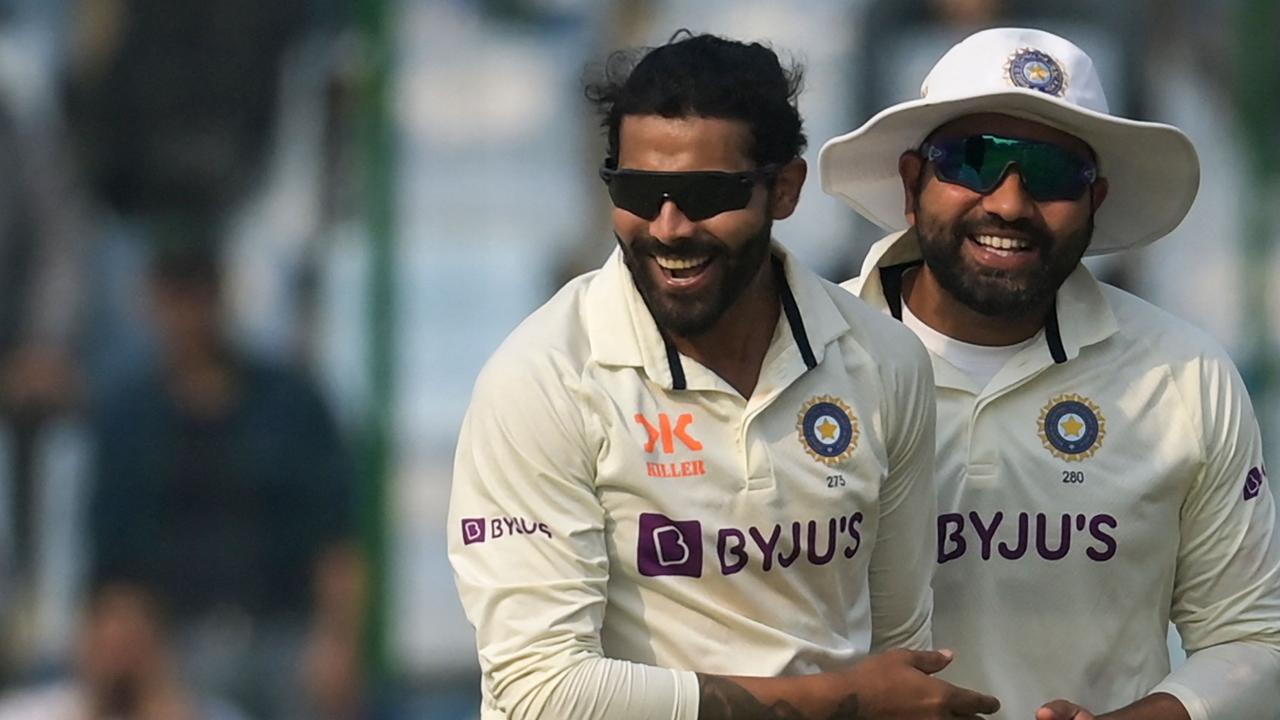 Ravindra Jadeja celebrates with teammate after the dismissal of Australia’s captain Pat Cummins. (Photo by Money SHARMA / AFP)