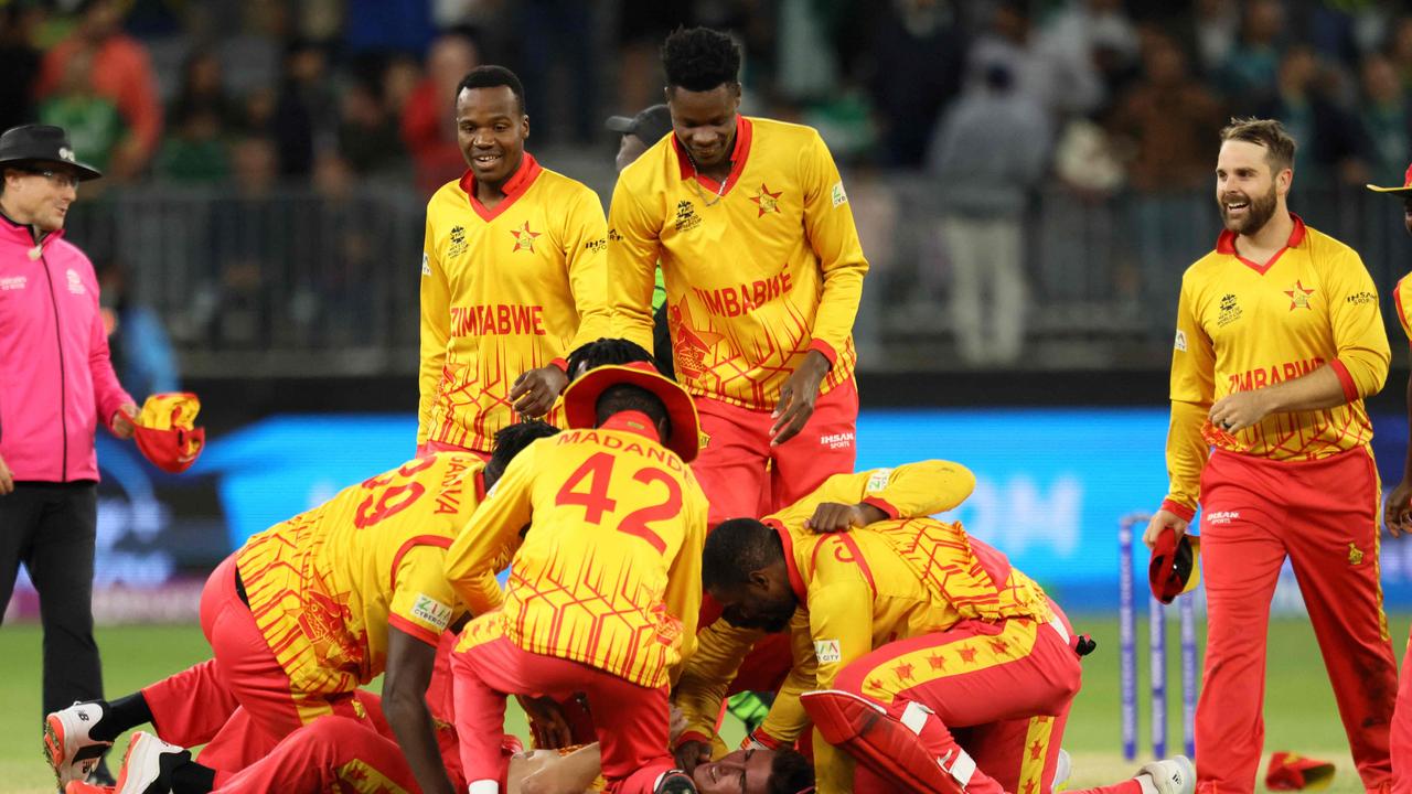 Zimbabwe's players celebrate their victory. Photo by TREVOR COLLENS / AFP.