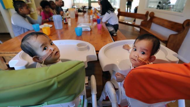 The girls Nima (left) and Dawa (right). having lunch with the other kids in the retreat. Picture: Alex Coppel 