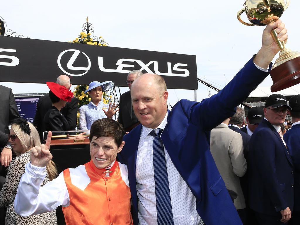 Vow And Declare’s jockey Craig Williams holds the Melbourne Cup with trainer Danny O'Brien after the stunning win.