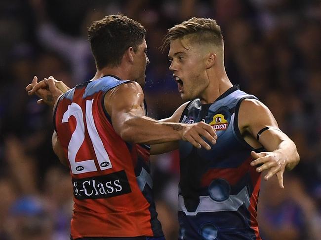 Tom Liberatore and Josh Schache of the Bulldogs react after Schache kicked a goal during the Round 1 AFL match between the Western Bulldogs and the Sydney Swans at Marvel Stadium in Melbourne, Saturday, March 23, 2019. (AAP Image/Julian Smith) NO ARCHIVING, EDITORIAL USE ONLY