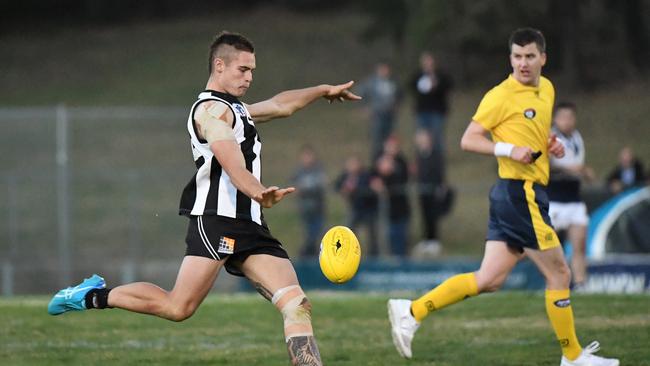 Luke Collins hoofs Montmorency forward during its victory over Bundoora in Round 3. Picture: James Ross.