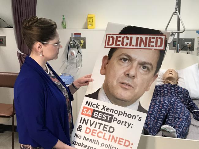 Nurses' union chief Elizabeth Dabars with poster criticising SA Best leader Nick Xenophon. Pic Brad Crouch