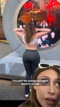 Adult model flashes her chest at NYC to Dublin portal