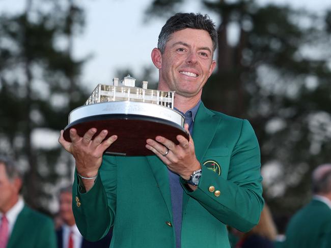 AUGUSTA, GEORGIA - APRIL 13: Rory McIlroy of Northern Ireland poses with the Masters trophy during the Green Jacket Ceremony after winning the 2025 Masters Tournament at Augusta National Golf Club on April 13, 2025 in Augusta, Georgia.   Richard Heathcote/Getty Images/AFP (Photo by Richard HEATHCOTE / GETTY IMAGES NORTH AMERICA / Getty Images via AFP)