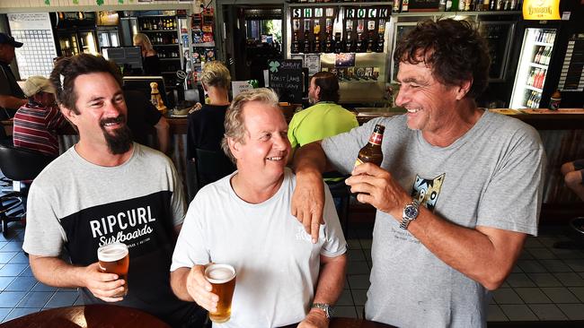 Mates Cheyne Timmermans, Chris Cockcroft and Frank Scharf have a beer at the Shamrock Hotel and talk all things Adani. Picture: Zak Simmonds