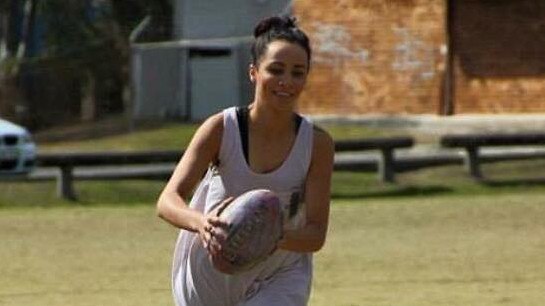 Tara Brown playing touch football.