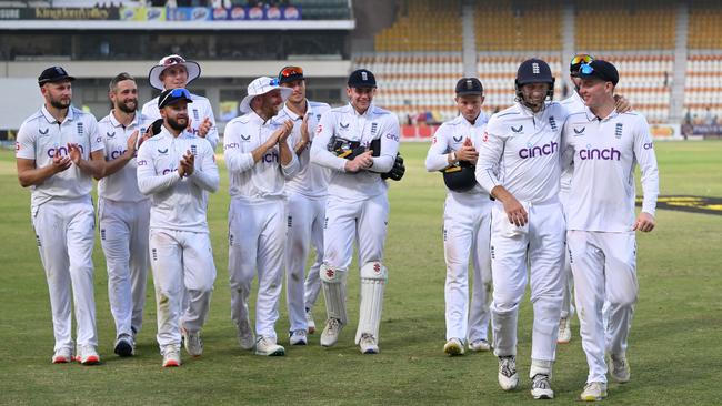 Harry Brook (right) and Joe Root are applauded by their teammates as they leave the field after day four of the First Test Match between Pakistan and England. (Photo by Stu Forster/Getty Images)