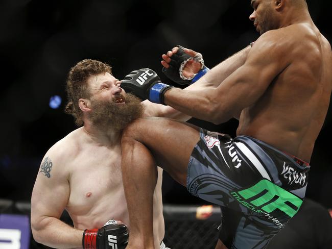 Alistair Overeem, right, of the Netherlands, knees Roy Nelson on the chin during a men's heavyweight UFC 185 mixed martial arts bout.