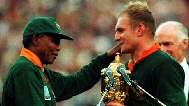 South African President Nelson Mandela hands over 1995 World Cup trophy to Springboks captain Francois Pienaar. Picture: AFP