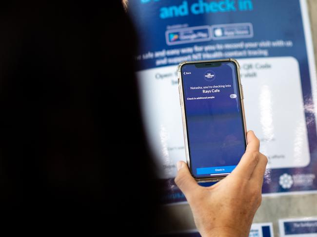 Health Minister Natasha Fyles demonstrates the new Northern Territory Check In App at Rays Cafe in Darwin. Picture: Che Chorley