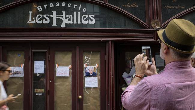 A man takes a photograph of notes and photographs left in memory of Anthony Bourdain at the closed location of Brasserie Les Halles, where Bourdain used to work as the executive chef, in New York City. Picture: Getty Images