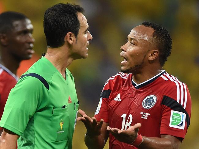 Colombia's defender Juan Camilo Zuniga (R) argues with Spanish referee Carlos Velasco Carballo during the quarter-final football match between Brazil and Colombia at the Castelao Stadium in Fortaleza during the 2014 FIFA World Cup on July 4, 2014. AFP PHOTO / EITAN ABRAMOVICH