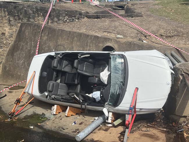 A man had to be cut free from his car which landed on its side in a water drain at Bundaberg Central.