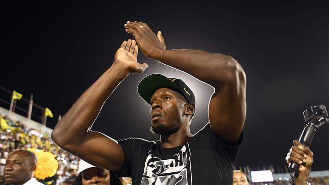 Olympic champion Usain Bolt greets the crowd at the national stadium in Kingston, Jamaica. Picture: AFP