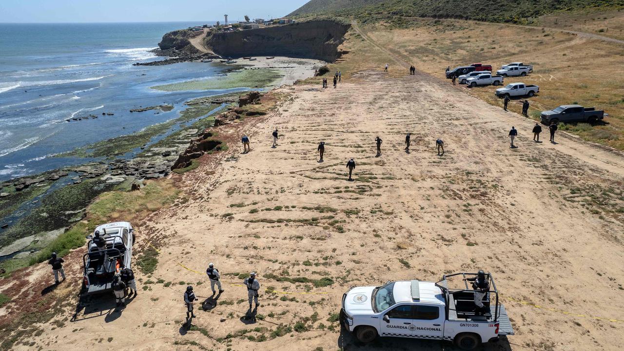 State prosecutors running a search at the site where the three surfers were camping before disappearing. Picture: Guillermo Arias / AFP